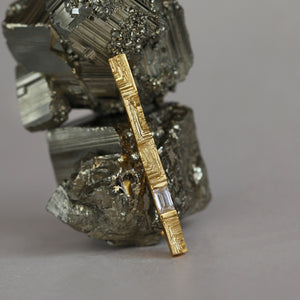 Intricate fine jewellery made from gold, with baguette shaped diamond and textured front, one of a kind collector's piece