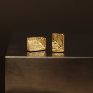 Cuboid 18ct gold stud earrings with hand-carved texture resembling mineral striations, gold earrings for men