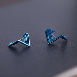 Artistic, geometric 18ct white gold stud earrings with handmade textured layers and blue nano-ceramic coating