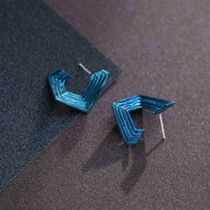 Geometric 18ct white gold stud earrings with handmade textured layers and blue nano-ceramic coating