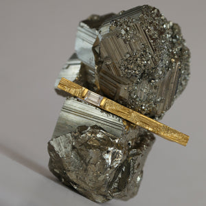 18ct yellow gold artistic brooch with diamond and intricate texture resembling mineral striations