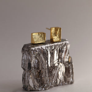 Geometric Xyz 18ct gold stud earrngs with hand-carved texture inspired by mineral striations, modernist gold earrings