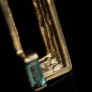 18ct gold lapel pin with handmade textured layers and blue tourmaline baguette, artistic jewellery