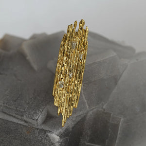 Amorphe sculpted 18kt gold modernist brooch with white tapered baguette diamonds and organic texture, detail.