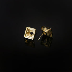 Cavetto modern statement stud earrings in 18kt yellow gold and square concave profile with textured layers.