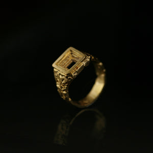 Sculptural Cavetto 18kt yellow gold statement signet ring with fire-sculpted texture and concave truncated layers, angled view.