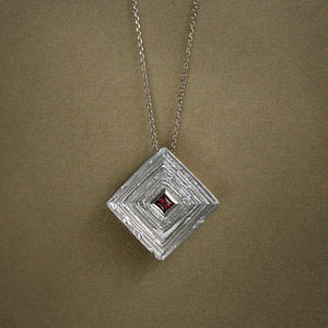 Statement 18kt white gold pendant necklace Corona Laminae with princess square dark pink rhodolite garnet and geometric layered silhouette.