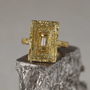 Scuptural Frustum 18kt molten gold statement cocktail ring with white baguette diamond and three-dimensional trapezoid angular crown, texture detail. 