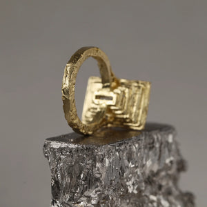 Frustum statement cocktail ring in 18kt yellow gold and baguette white diamond, with stratified expansive construction, rear view.