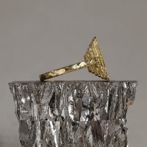 Statement 18kt gold Frustum ring with white baguette diamond and fire-textured ascending layers, side view. Part of the Classical collection.