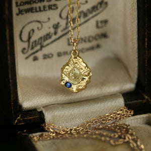 Lava Jonquil statement unisex pendant necklace in 18kt gold, pear yellow diamond and blue sapphire accent, in sculpted setting, presented on a vintage box.