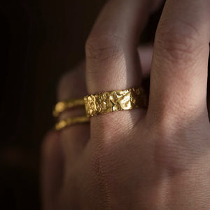 Liquid Aurum Alto set of three 18kt gold statement rings with rusticated raw texture, on hand.