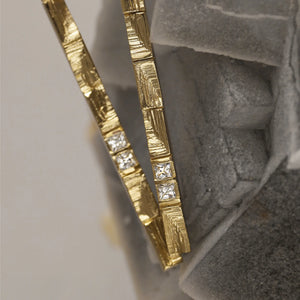 XYZ Parallax 18kt gold statement drop earrings with princess-cut white diamonds, stone setting details.