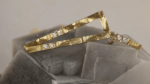 XYZ Parallax statement 18kt gold elongated drop earrings with 0.8ct white baguette diamonds and hand-carved details, side view. Part of the Cartesian Collection.