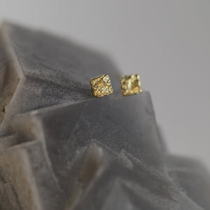 Tessara 18kt yellow gold unisex statement stud earrings with fire-sculpted rusticated texture and tile-shaped design.