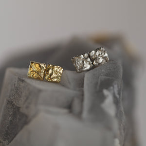 Set of two Tessara unisex statement stud earrings in white and yellow 18kt sculpted gold.