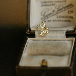 Diamond earrings displayed on a vintage jewellery box