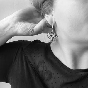 Iris Laevigata Statement 18kt gold and silver drop earrings with yellow diamonds, baguette cut orange madeira citrines,and blue rhodium, on model.