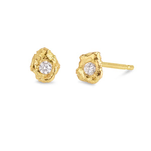 Lava Blanc raw 18kt gold everyday stud earrings with brilliant white round diamonds and molten texture in a close-up.